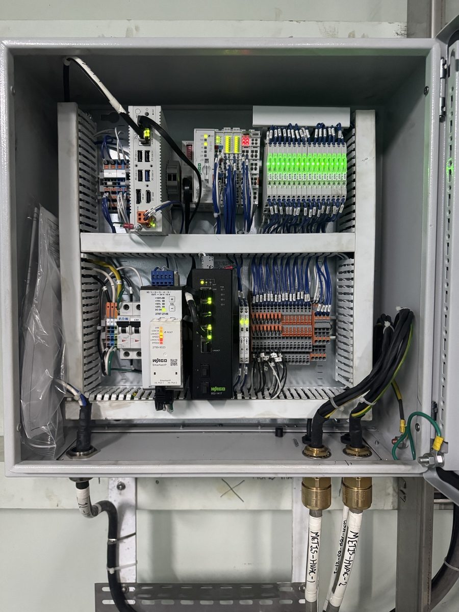 Open WAGO edge compute enclosure aboard West Saturn, with edge controllers, I/O modules and a network switch on DIN rails.